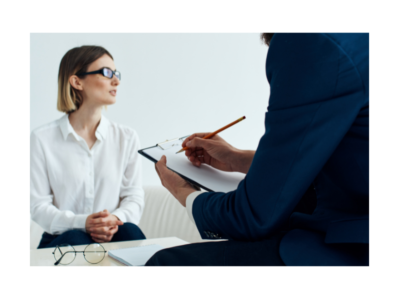 woman with glasses talking to lawyer with notepad